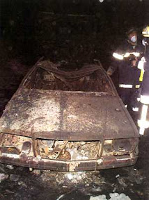 Remains of a car. According to The Italian Junkyard, the seat belts were still engaged, and human bones could be found on the car's floor.