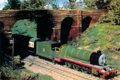 Henry going under a wide-arched bridge.