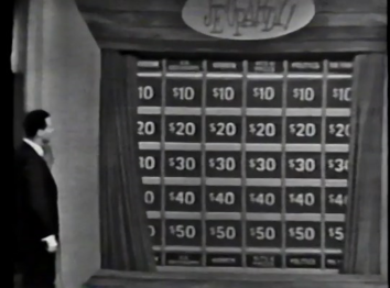 The curtian revealing the board for round 1 (Note that the categories are on the bottom as well as the top).