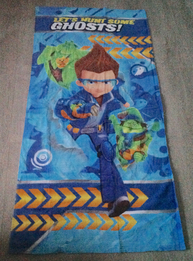 B.O.O. branded beach towel, featuring renders of Henry, Smelvin, and Drake with his dog Lionel.
