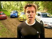 Footballer Graeme Le Saux in front of a group of road-bred rally cars.