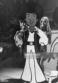 A still showing the two Brady kids and a member of the Jackson 5.