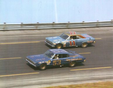 Bud Moore (53) ahead of Mario Andretti (11). Both failed to finish after Moore suffered a throttle failure, while Andretti crashed out.