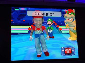 Screenshot of the game featuring a player being given Mario's clothes after being designated as a designer.