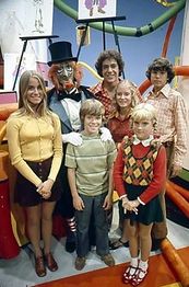 A still showing Voo Doo the Magician and the Brady Kids.