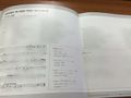 Inside of the jacket, with lyrics, definitions and sheet music in English and Japanese for "A Week in Our Time Machine". Please note that text and sheet music has been blurred out by the original uploader.
