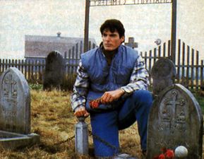 Clark visits his adoptive parents' graves.