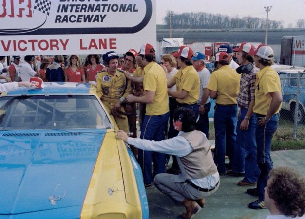 Earnhardt exiting his car to celebrate with his crew.