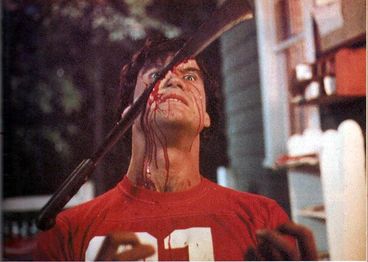 A facing shot of Mark's face being split by the machete.